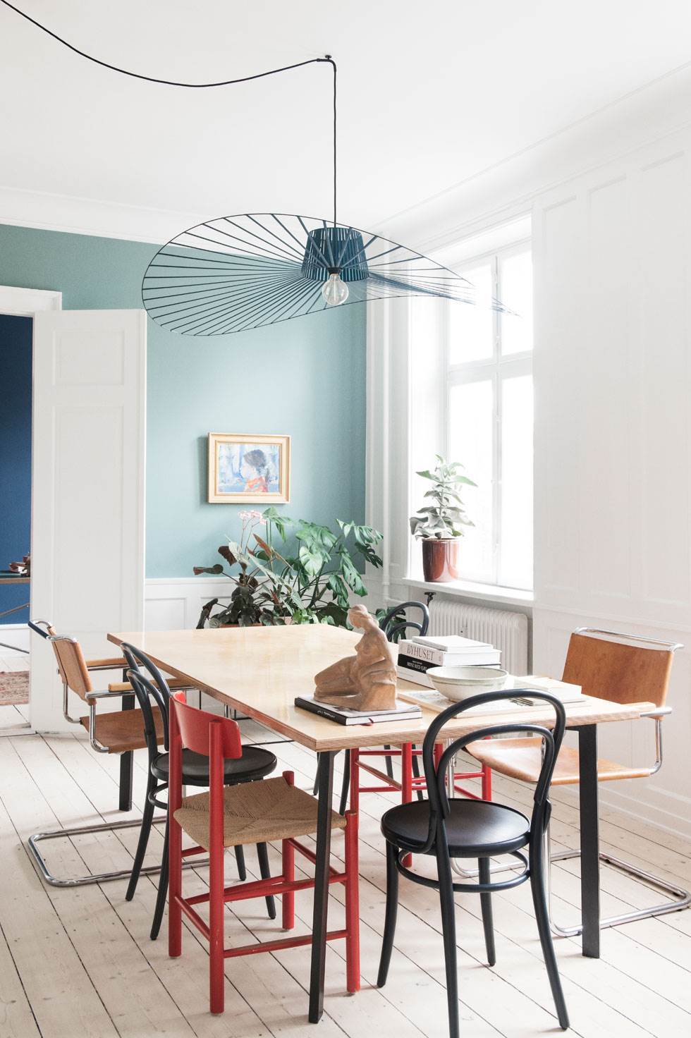 Læderstole fra Thonet er fundet på Lauritz.com, og de grå Thonetstole er fra New York. De røde skolestole er en gave, spisebordet har Trine og Mads selv lavet, lampen er fra Beau Marche. Væggen er malet med Oval room blue fra Farrow and Ball. Foto: Gyrithe Lemche