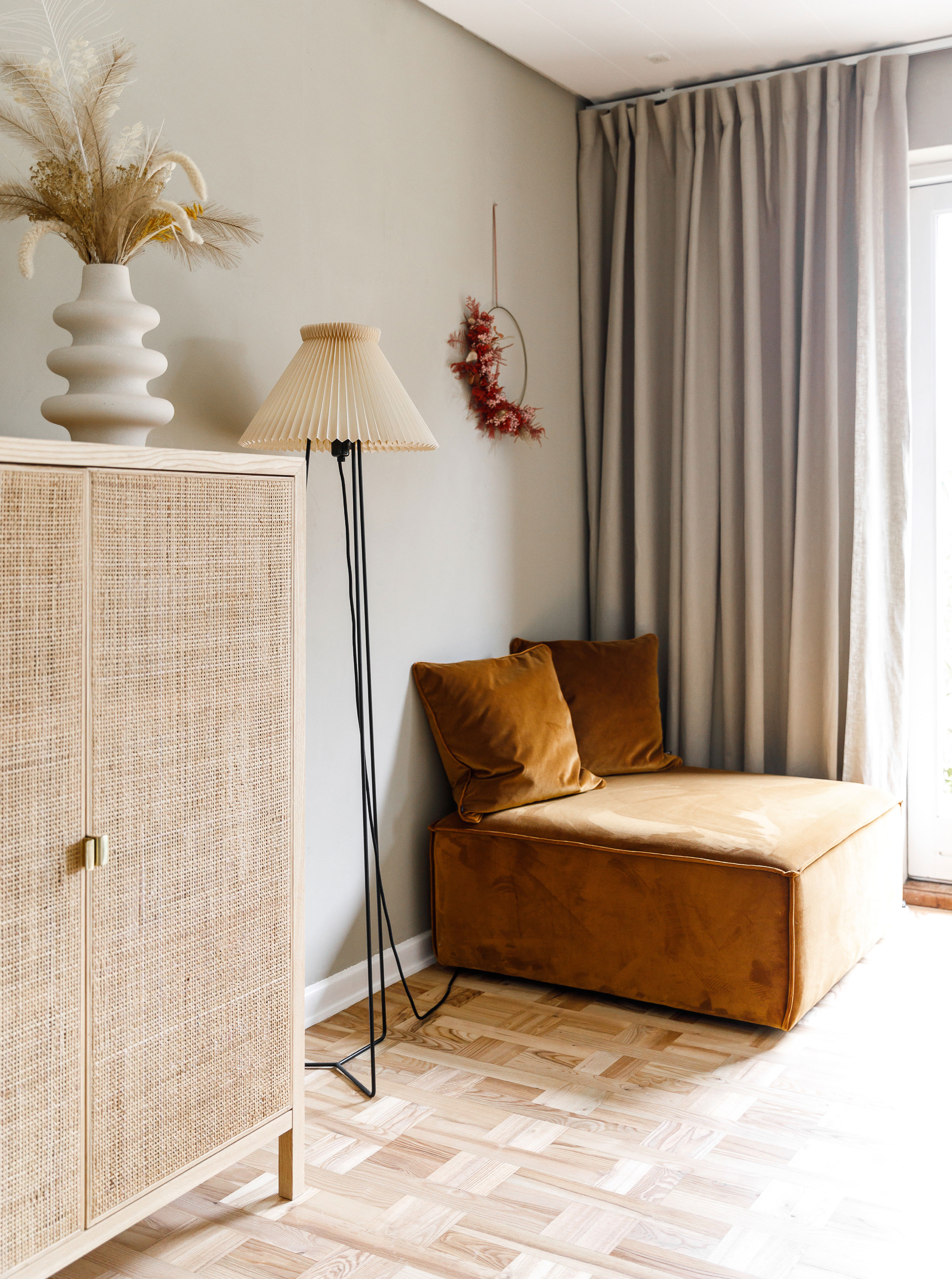 Vægfarven er fra Jotun og hedder Raw Canvas, pufmodulet er fra Sofacompany, hørgardinet og skabet er fra Ikea, vasen er fra H&M Home, og standerlampen er fra Lampefeber, med en nymonteret Le Klint-skærm.